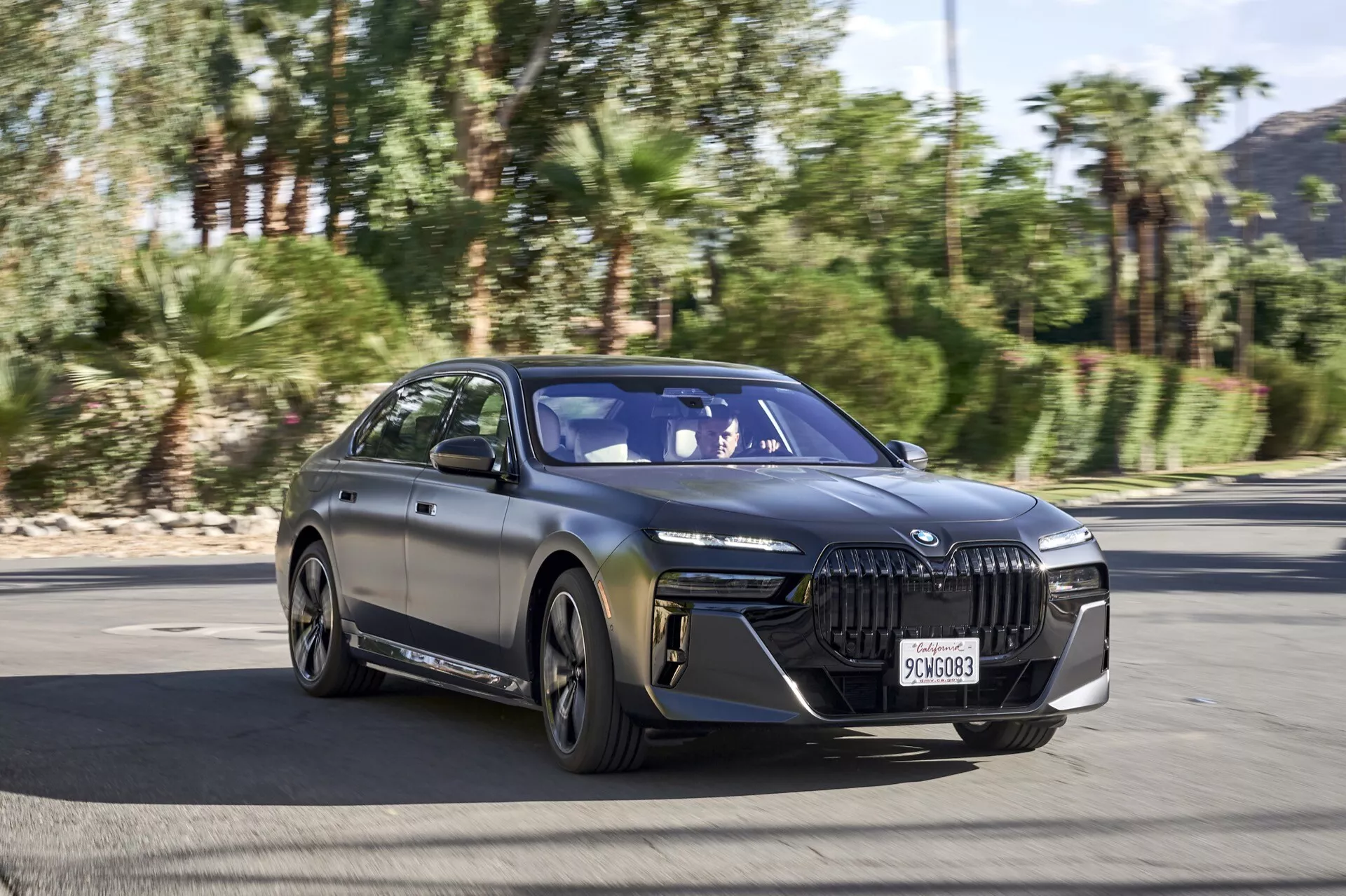 Berlina di lusso elettrica BMW i7 G70 2022 in movimento su un'autostrada, che mostra il suo design elegante e le avanzate caratteristiche tecnologiche