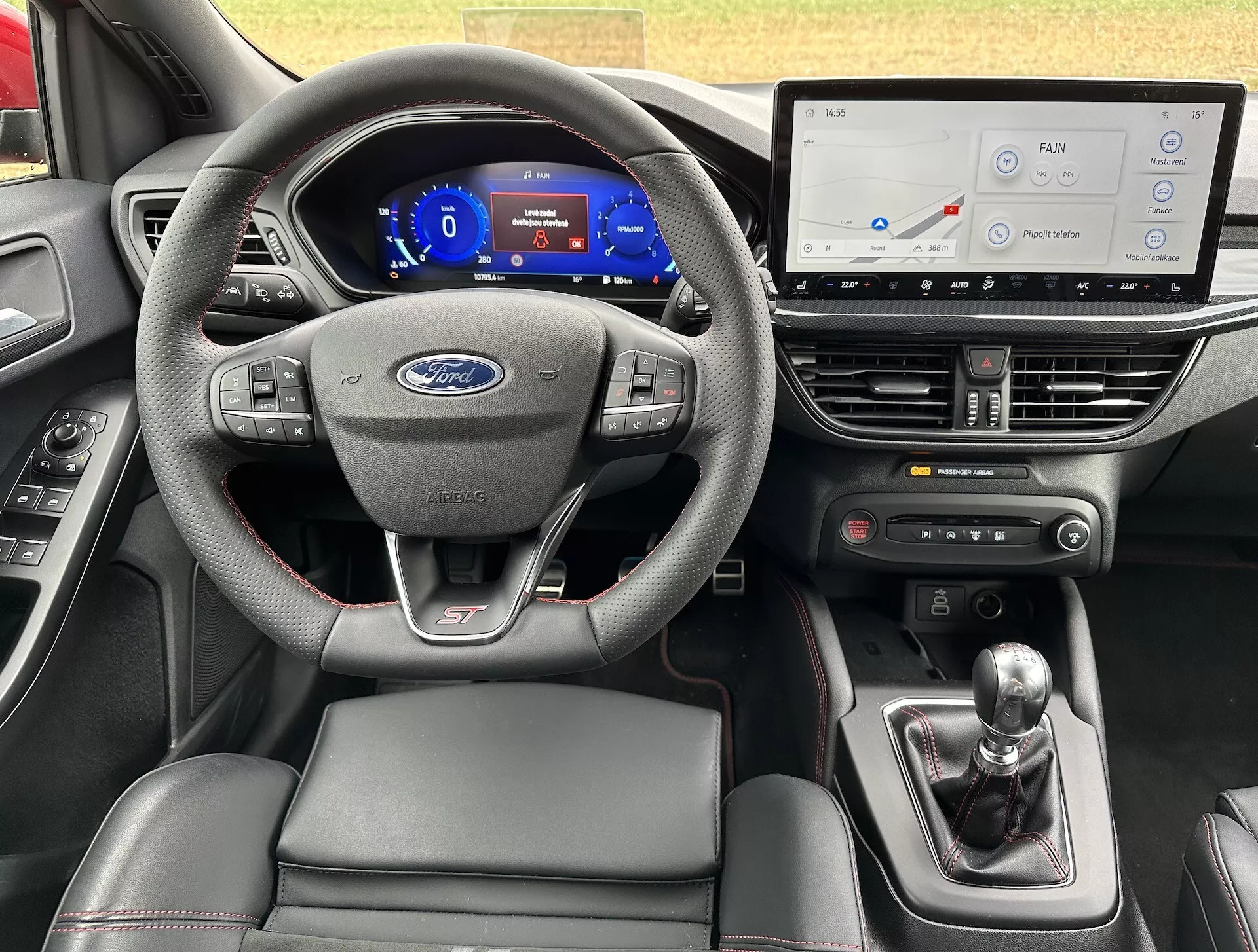 Vista interna della Ford Focus ST 2022 con display digitali, volante sportivo e cambio manuale, caratterizzata da tecnologia avanzata e design
