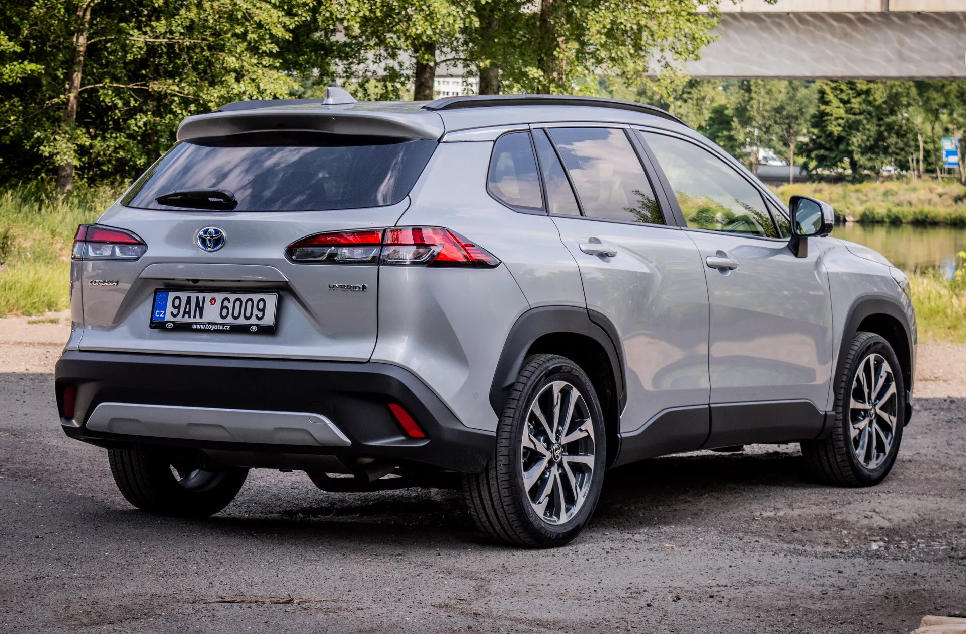 SUV compatto ibrido Toyota Corolla Cross 2022 che mostra fari posteriori LED avanzati, ruote in lega e caratteristiche di sicurezza da una visuale posteriore a tre quarti.
